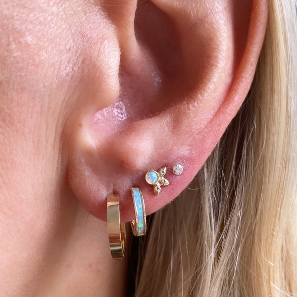 This is every girls dream ear. In the first hole is our classic cool girl hoops followed by the gold and opal inlay hoops. In the third hole our cult classic Beatrix Australian opal studs and finally our stardust studs.