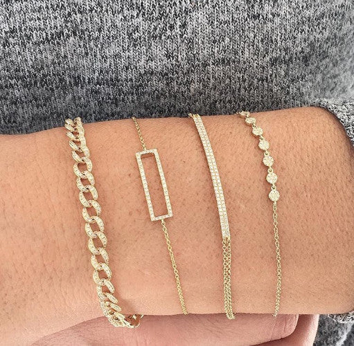 Four Stacked Gold and Diamond Bracelets