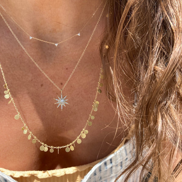 This trois diamond necklace is paired with the Sia Taylor long random dots necklace and the sunburst diamond necklace