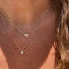 the tiny diamond disc necklace is paired with our marquise of wisdom diamond and white topaz necklace