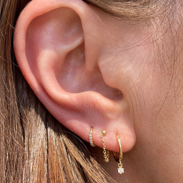 The starry night diamond drop hoop earrings pair perfectly with out chained together studs and the tiniest diamond huggie hoops.