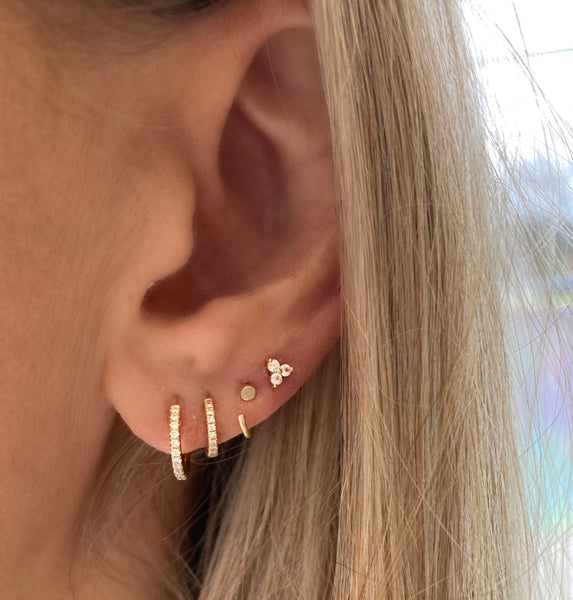 Katie Diamond Jewelry's Ava Diamond Huggie Hoop Earrings styled on an ear.