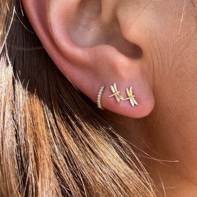 These dragonfly inn studs are pictured with our tiniest diamond huggie hoops.