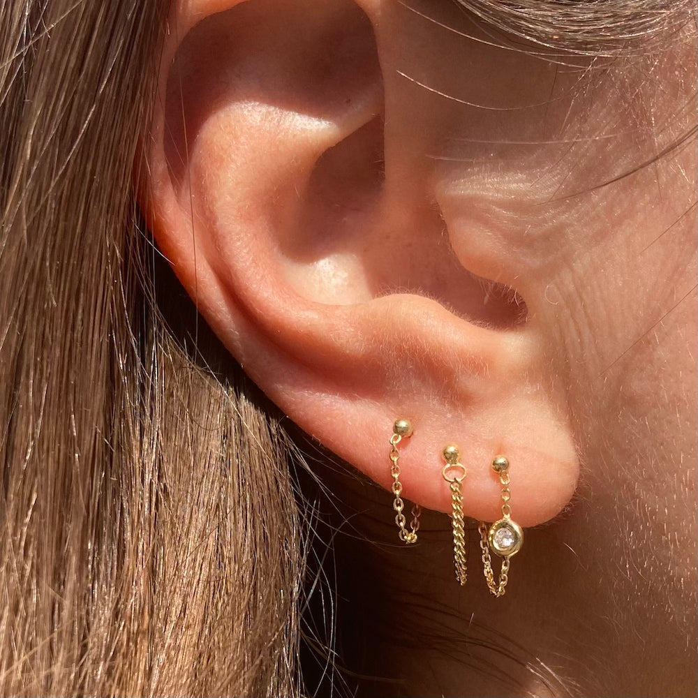The diamond bezel chain earrings are paired with our best selling chained together studs and a new addition the curb chained together studs 