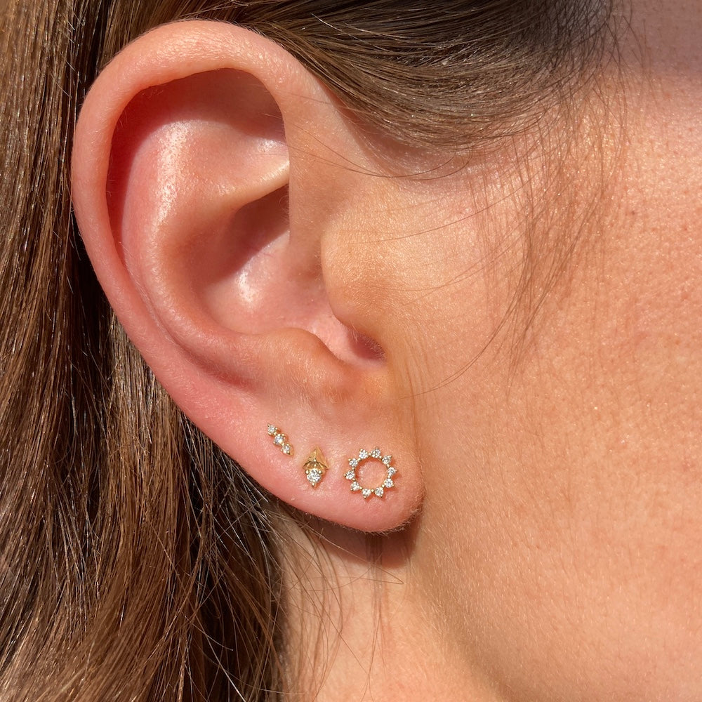 Three Gold and Diamond Stud Earrings on Ear