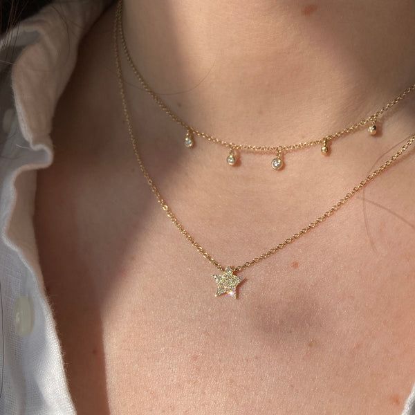 The yellow gold dew drop diamond station necklace is paired with our pave diamond star necklace.