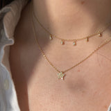 The pave diamond star necklace is pictured with the dew drop diamond station necklace.