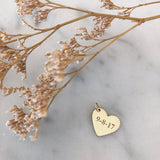 gold heart charm engraved with a date