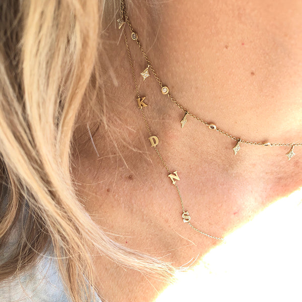 layered gold station and initial necklaces