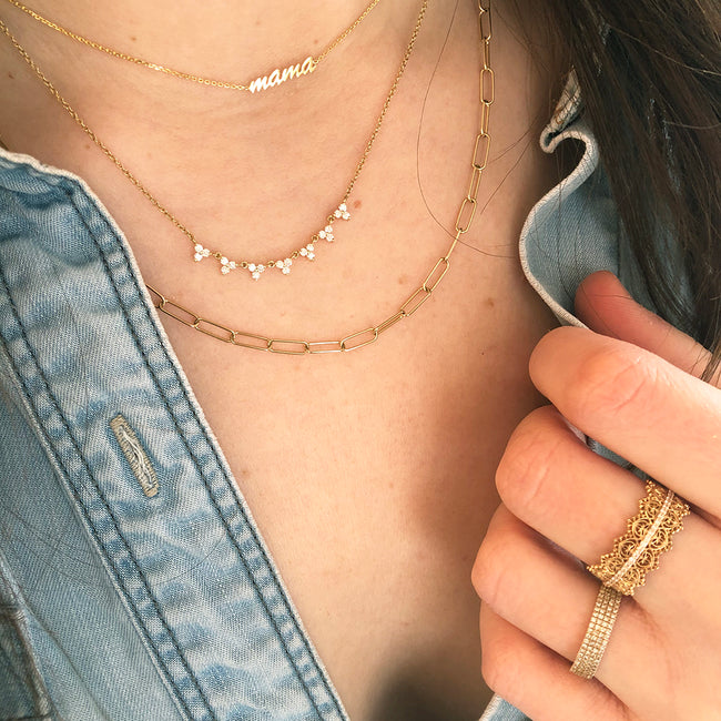 Layered Gold and Diamond Necklaces and Rings